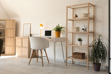 Interior of modern room with comfortable armchair near table