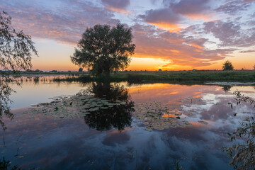 Warm summer morning on the lake before sunrise 