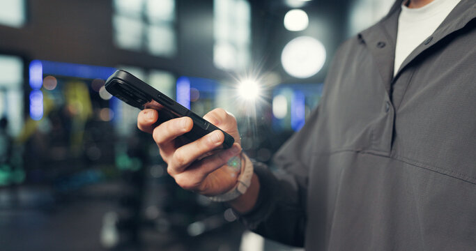 Fitness, gym and hands of person with phone on mobile app for health, wellness and track workout. Sports center, typing and man on smartphone for internet, exercise website and training progress