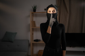 Secret thief. Robber woman say hush be quiet shh gesture. Silence and Shh