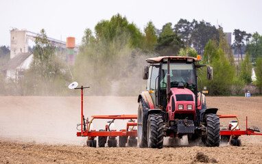 The tractor is used to sow seeds in the field using a specialized device. The tractor is a powerful...