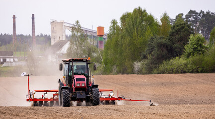 The tractor is used to sow seeds in the field using a specialized device. The tractor is a powerful...