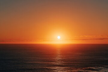Fototapeta premium Wide shot of a fiery sunset over a vast ocean