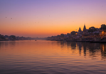 Fototapeta premium Serene Sunrise Over a Spiritual City Reflecting on the Water