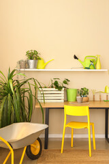 Interior of workshop with gardening tools, workplace and shelf