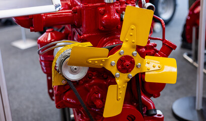 Close-up shot of engine fan. New red internal combustion engine close-up. Diesel engine motor of...