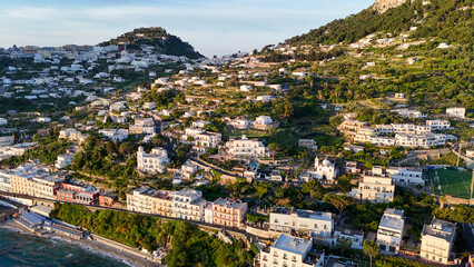 Breathtaking coastal view of the serene hillside village nestled in lush greenery at sunset