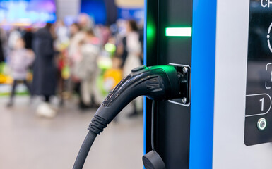 Electric car connected to charging station. Electric car charging. Concept of EV car and home...