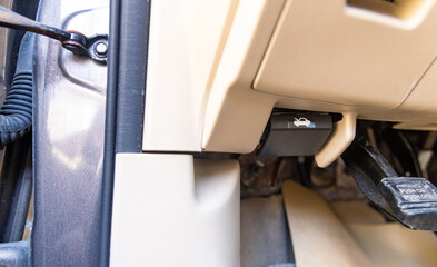 Car bonnet release lever, car interior. Hand pulling car bonnet release - button for open car hood