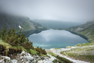 Czarny Staw pod Rysami in the High Tatras. Misty mountain landscape.
