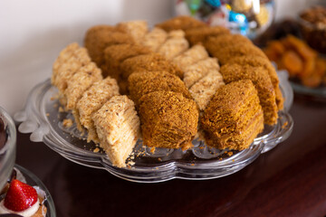 A beautifully arranged platter displays an enticing selection of layered desserts, featuring...