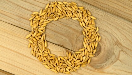 Oat grains arranged to form a letter O on a wooden surface