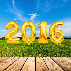 Golden balloons spelling 2016 against a summer meadow