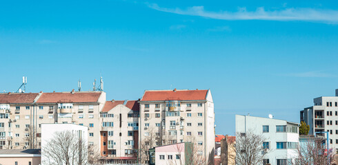 Blocks with many modern residential apartments in a residential area and a background of blue sky. ...