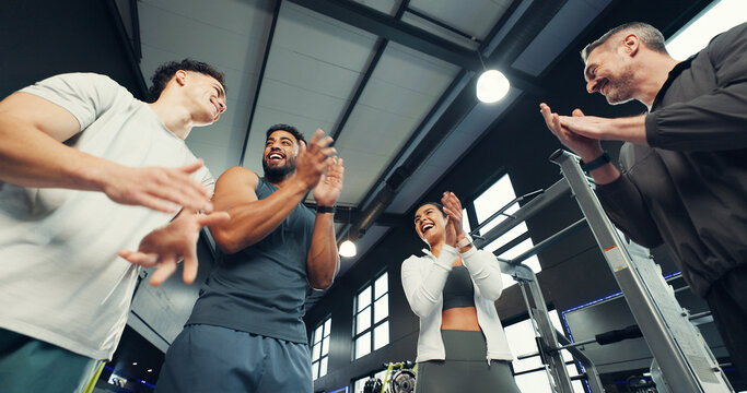Fitness, group and happy with applause at gym for exercise progress, training victory and low angle. Sports club, people and celebration for teamwork goals, workout achievement and wellness support