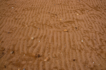 Sand on the beach with streaks after the rain.