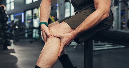 Exercise, knee pain and hands of person in gym for physical training or workout accident. Fitness, injury and legs with hurt athlete in health club for emergency, joint inflammation or strain