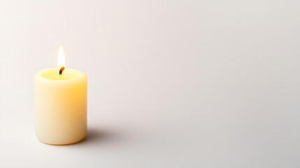 Burning candle on plain background, serene indoor setting