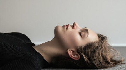 Young woman lying peacefully indoors during daytime