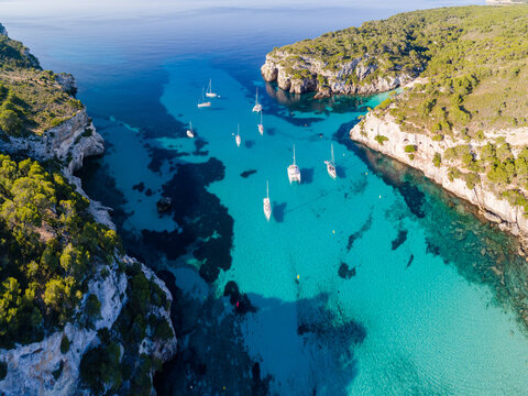 Aerial of bay and yachts, Cala Macarella, Menorca