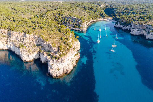 Aerial of coastline with yachts, Cala Macarella, Menorca