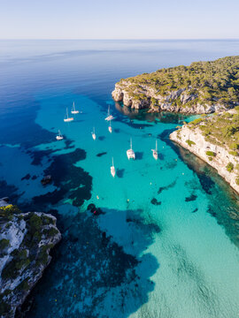 Aerial of bay and yachts, Cala Macarella, Menorca