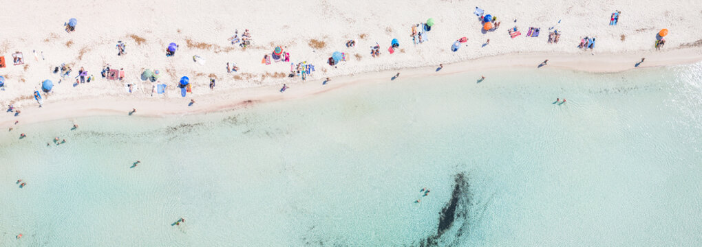 Aerial top down panorama of beach crowded with people, Spain