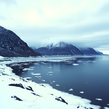Frozen Vestpolltjonna bay-Ruiten and Langstrandtindan mounts background. Austvagoya-Nordland fylke-Norway. 0108