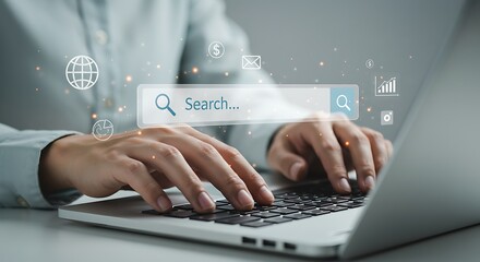 Close-up of hands typing on a laptop keyboard with a search bar overlay.