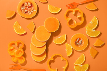 Composition with fresh vegetables on orange background, closeup