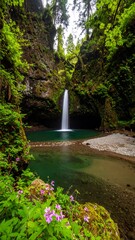 Lush waterfall cascading into a tranquil pool nestled within a verdant forest