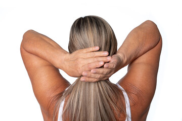 Woman with long hair holds her head in an outdoor setting, showcasing relaxation and calmness...