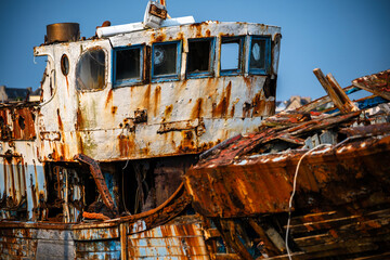 Old boats rusting away in shipping and fishing port
