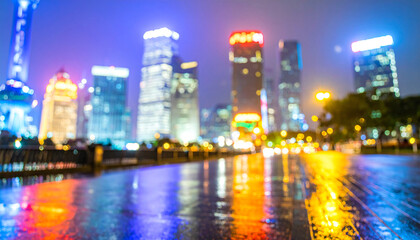 Obraz premium Rainy night street illuminated by car headlights with reflections on wet pavement in a city setting