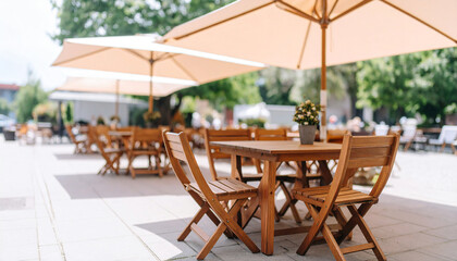 Obraz premium Chairs under parasol umbrellas in front of the swimming pool in a beautiful boutique spa hotel resort