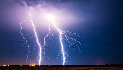 Dramatic lightning storm over a field at night