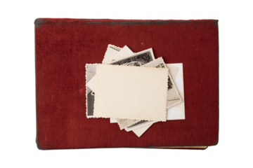 Empty vintage photo cards over dark red covered retro album. Closed retro photo album with blank cards.