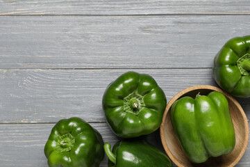 Bowl with green bell peppers on grey wooden background
