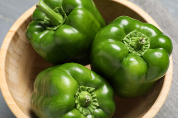 Bowl with green bell peppers on grey wooden background, closeup