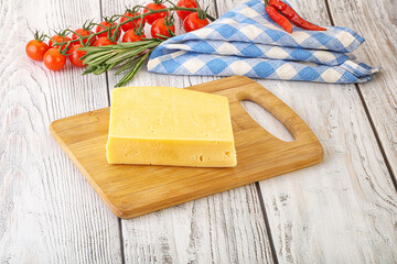 Piece of natural organic cheese over board
