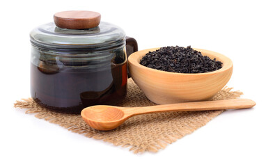 Black tea in glass teapot with wooden bowl and spoon