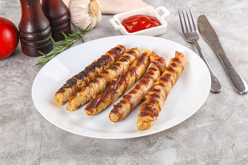 Grilled meat sausages wrapped bacon