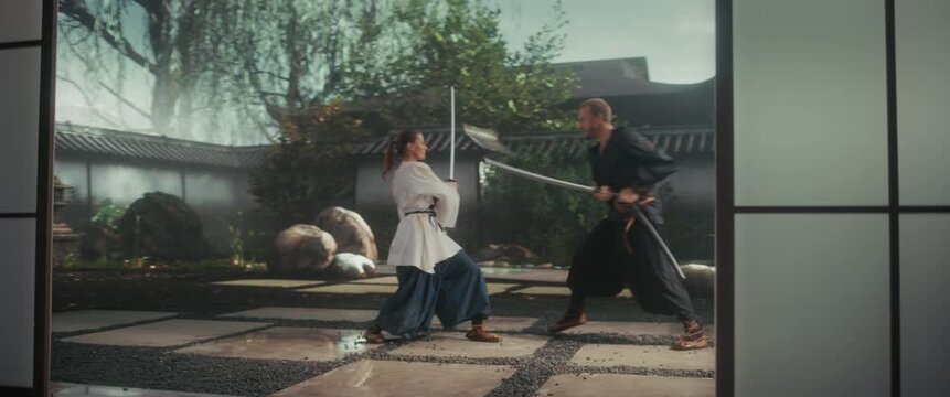 Male and Female Samurai Engaged in a Tense, Cinematic Sword Fight on a Historic Japanese Courtyard. Battle Blends Performance Art with Realistic Fighting Techniques. Footage with Dynamic Camera Angles