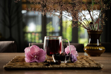 Refreshing herbal drink with flowers on a table in a cozy setting during late afternoon