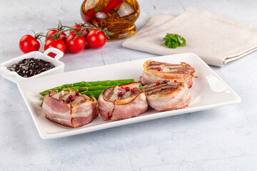 Tasty grilled pork medallion with bacon