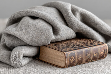 antique prayer book rests elegantly on soft woolen blanket its intricate patterns and worn leather binding telling