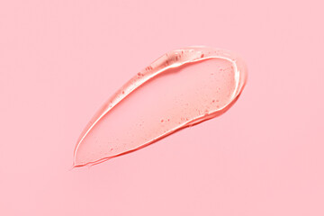 Smear of snail mucin gel on pink background