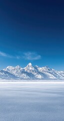 Obraz premium Vast expanse of frozen terrain, snow-capped mountains rise against a brilliant blue sky