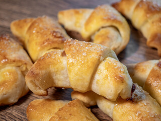 Yeast crescent rolls with rose jam sprinkled with sugar
