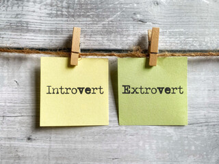 Personality concept - Introvert extrovert text on notepaper background. Stock photo.